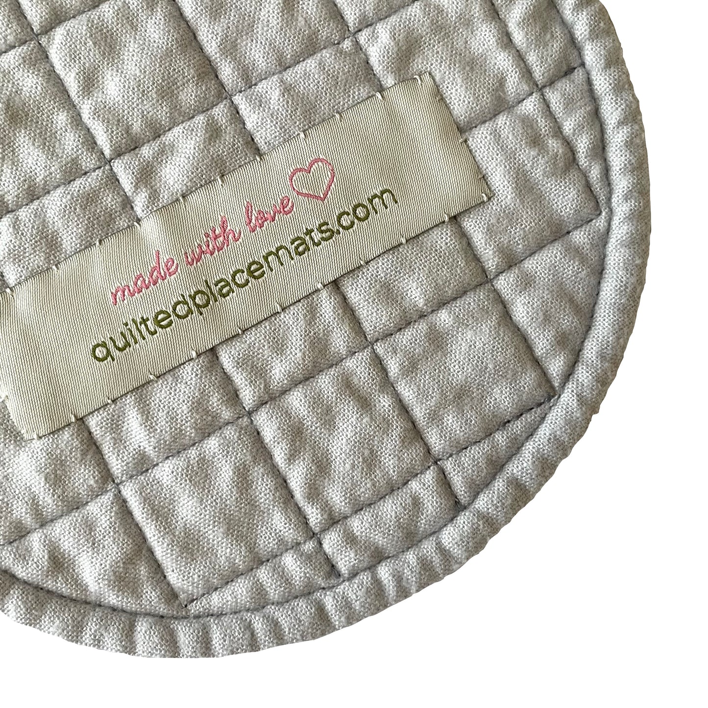 Grey backside of smiling flower saucer mat / mug mat.
