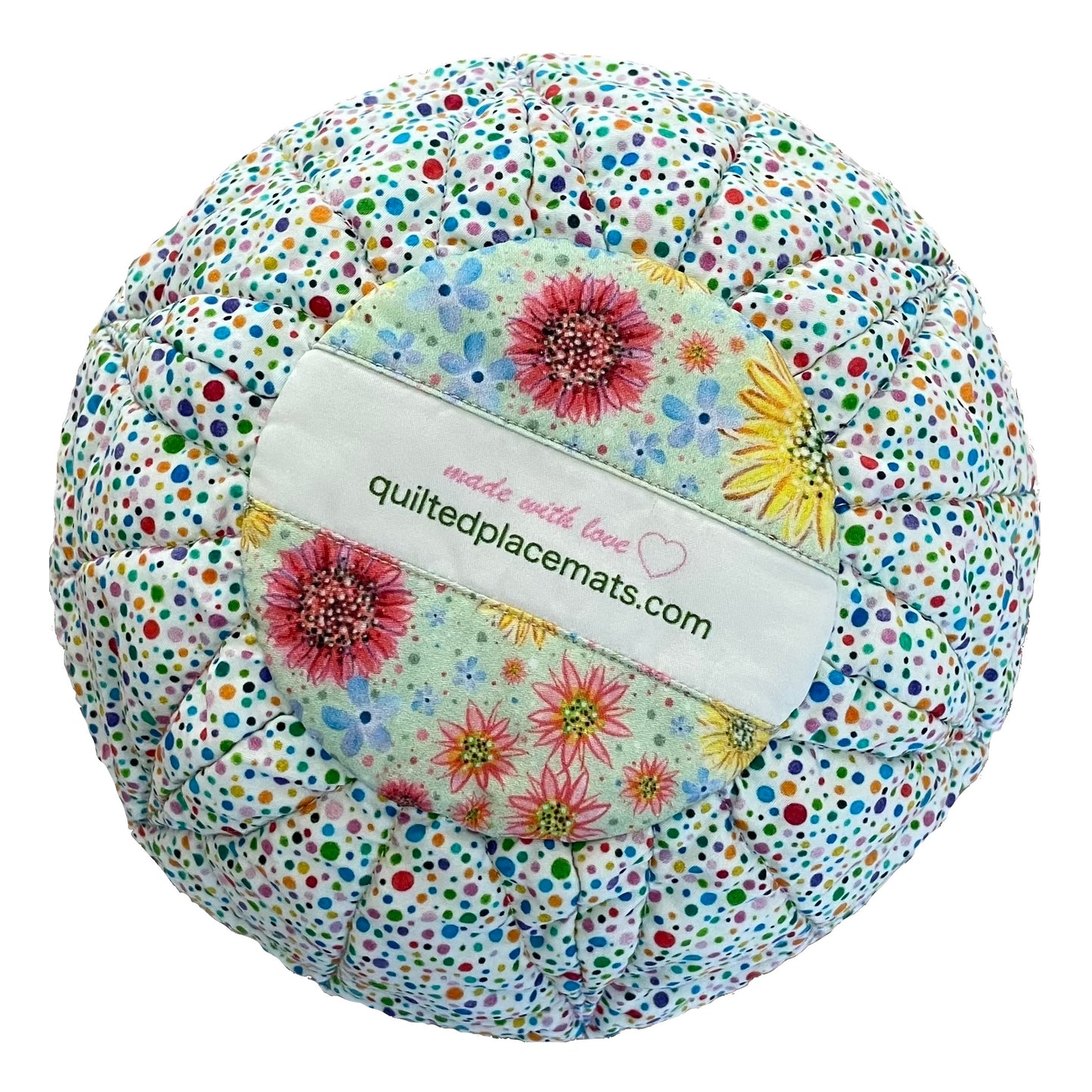 Quilted bowl cozy bottom view in rainbow polka dots and floral design showing label.
