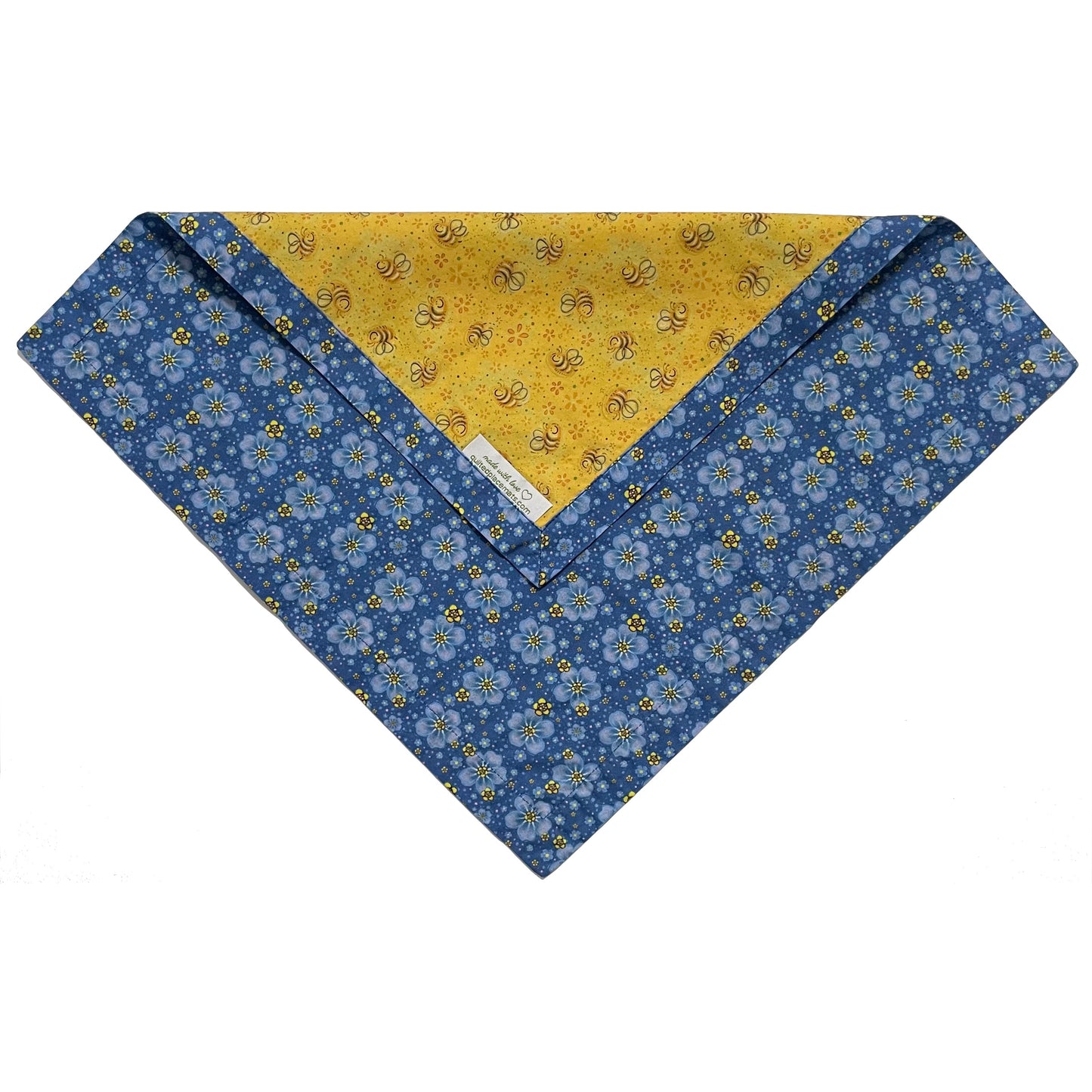 Folded edge of blue floral and yellow bees cloth napkin.