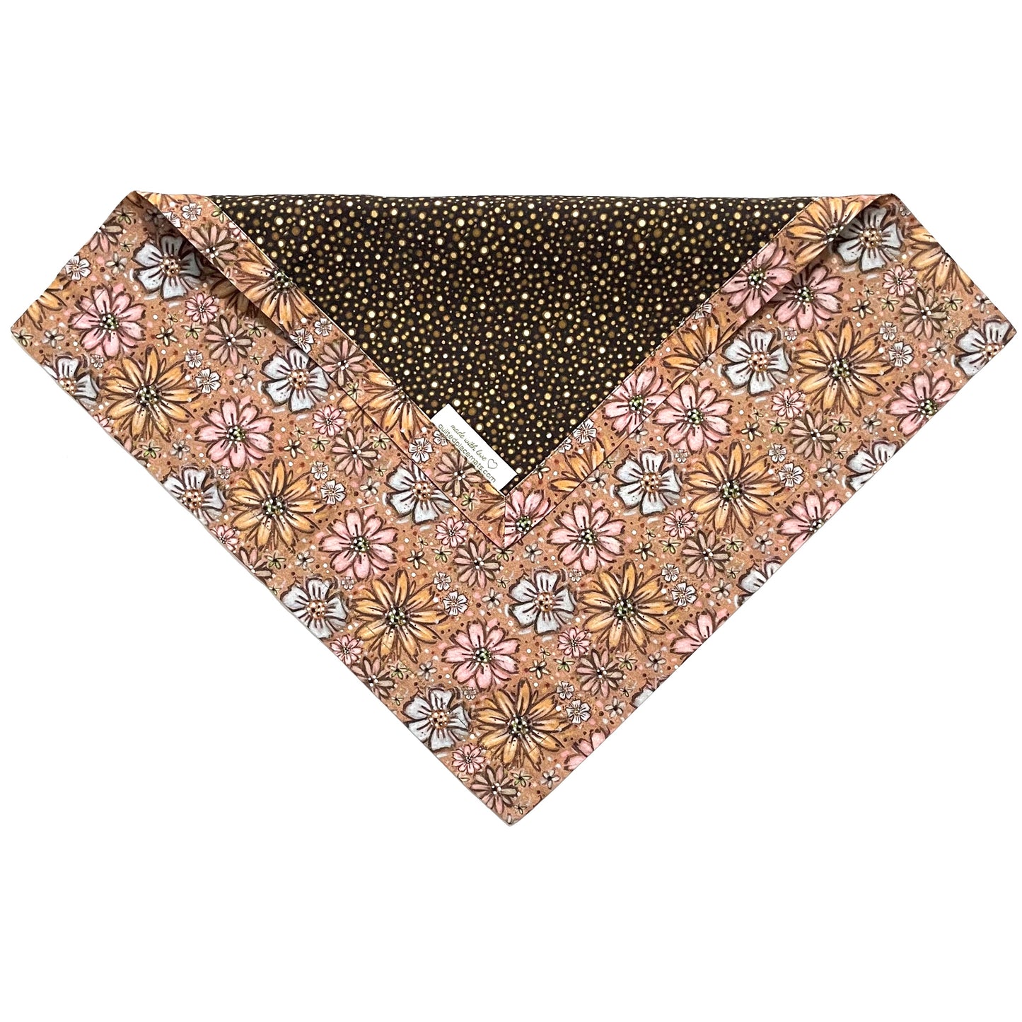 Folded edge of pink, yellow, blue floral on light brown background and dark brown polka dots cloth napkin.