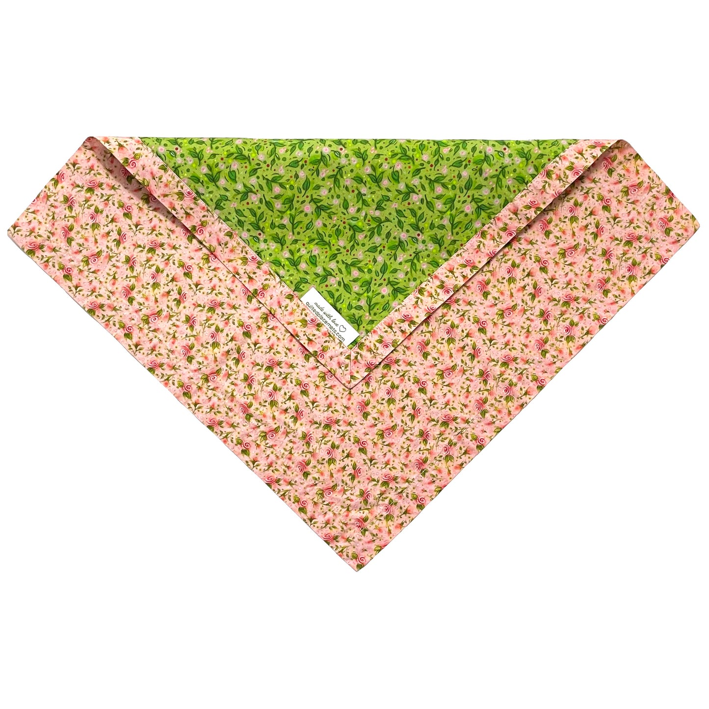 Folded edge of green leaves and pink tea roses design cloth napkin.