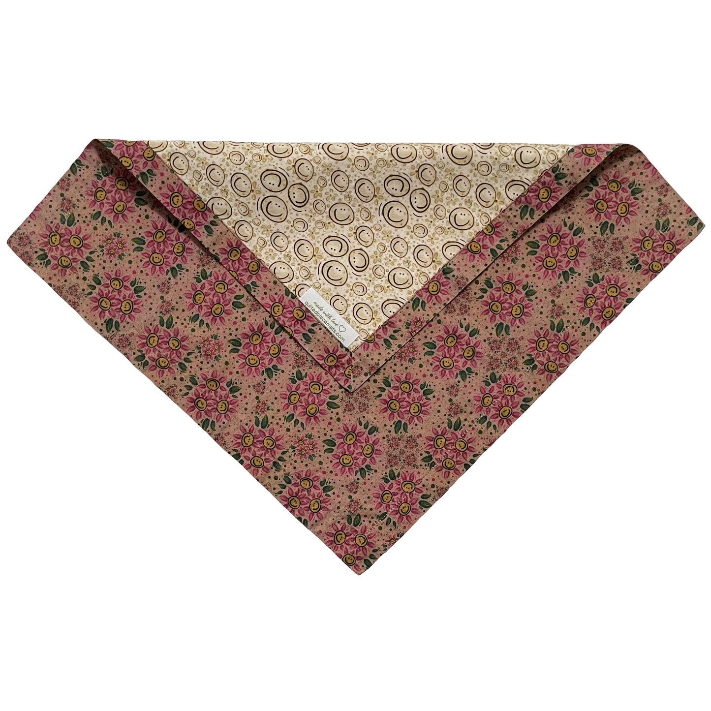 Folded edge of smileys on beige background and rose-gold and dark pink smiling daisies cloth napkin.