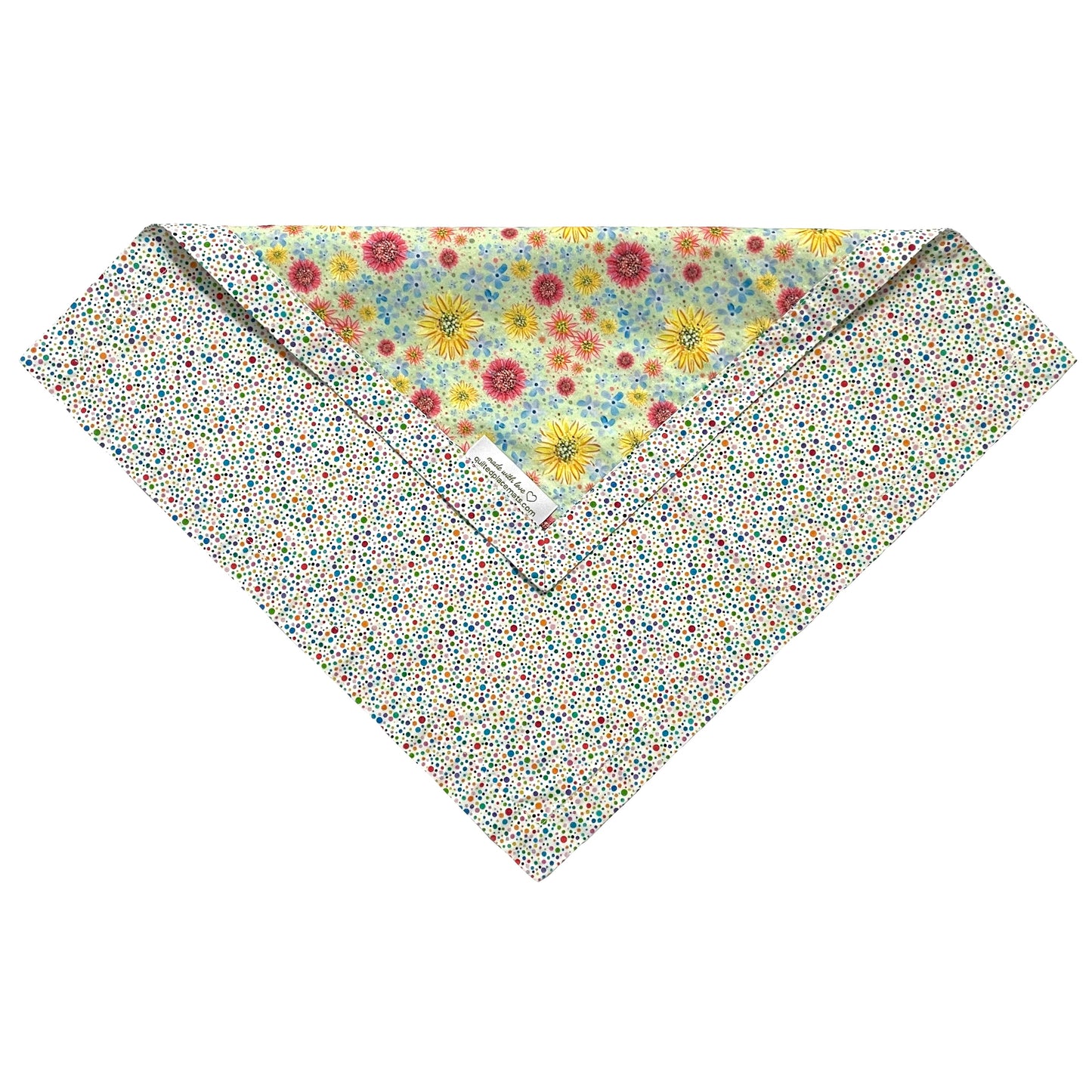 Folded edge of multicolored polka dots and wildflowers cloth napkin