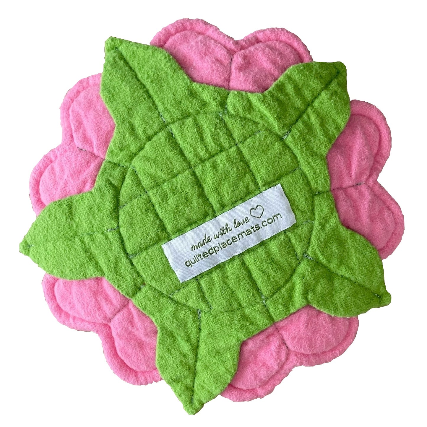 Quilted flower mug mat, mini mat, saucer mat, coaster back view in pink and green showing label.
