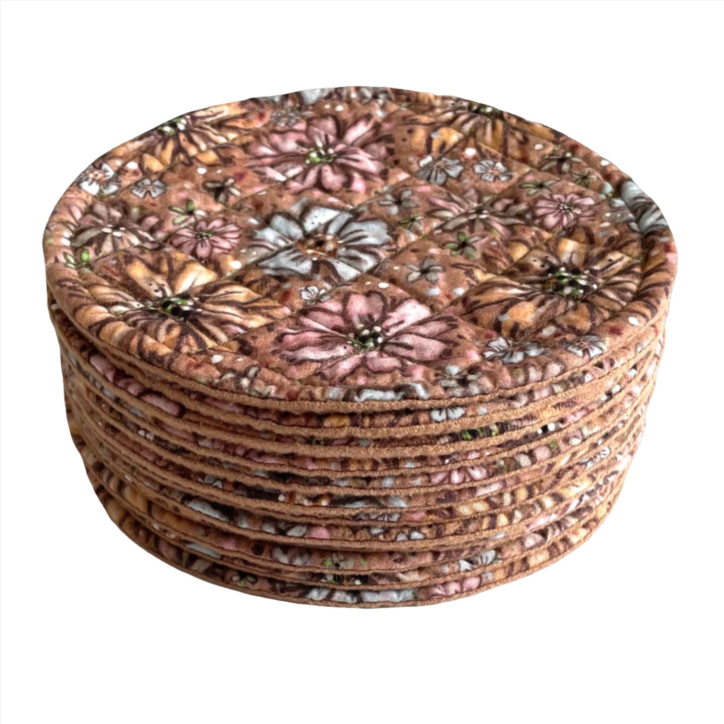 Stack of round quilted mug mats, mini mats, saucer mats, coasters in floral design with light brown background.