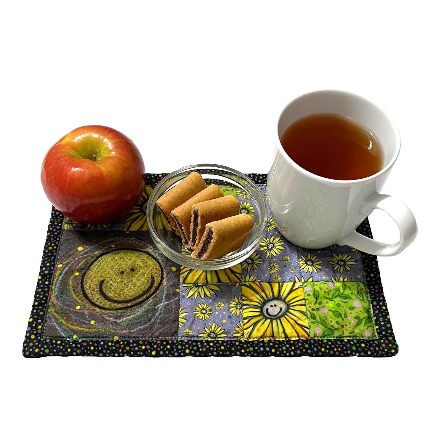 Smiley fabric design mug mat, mini mat, snack mat, coaster showing tea, apple and cookies place setting.