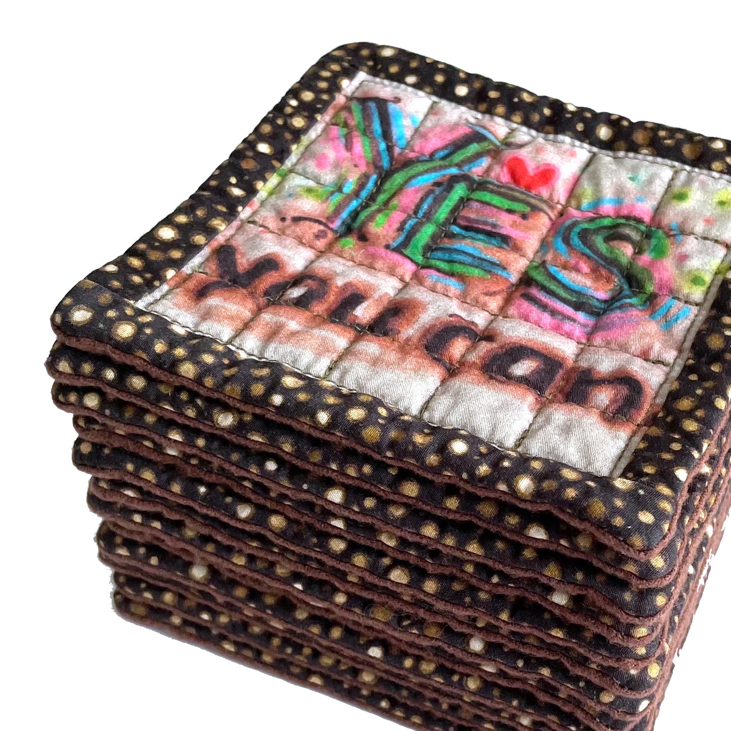 Stack of quilted mug mats, mini mats, saucer mats, coasters in brown with Yes You Can design and polka dot border.