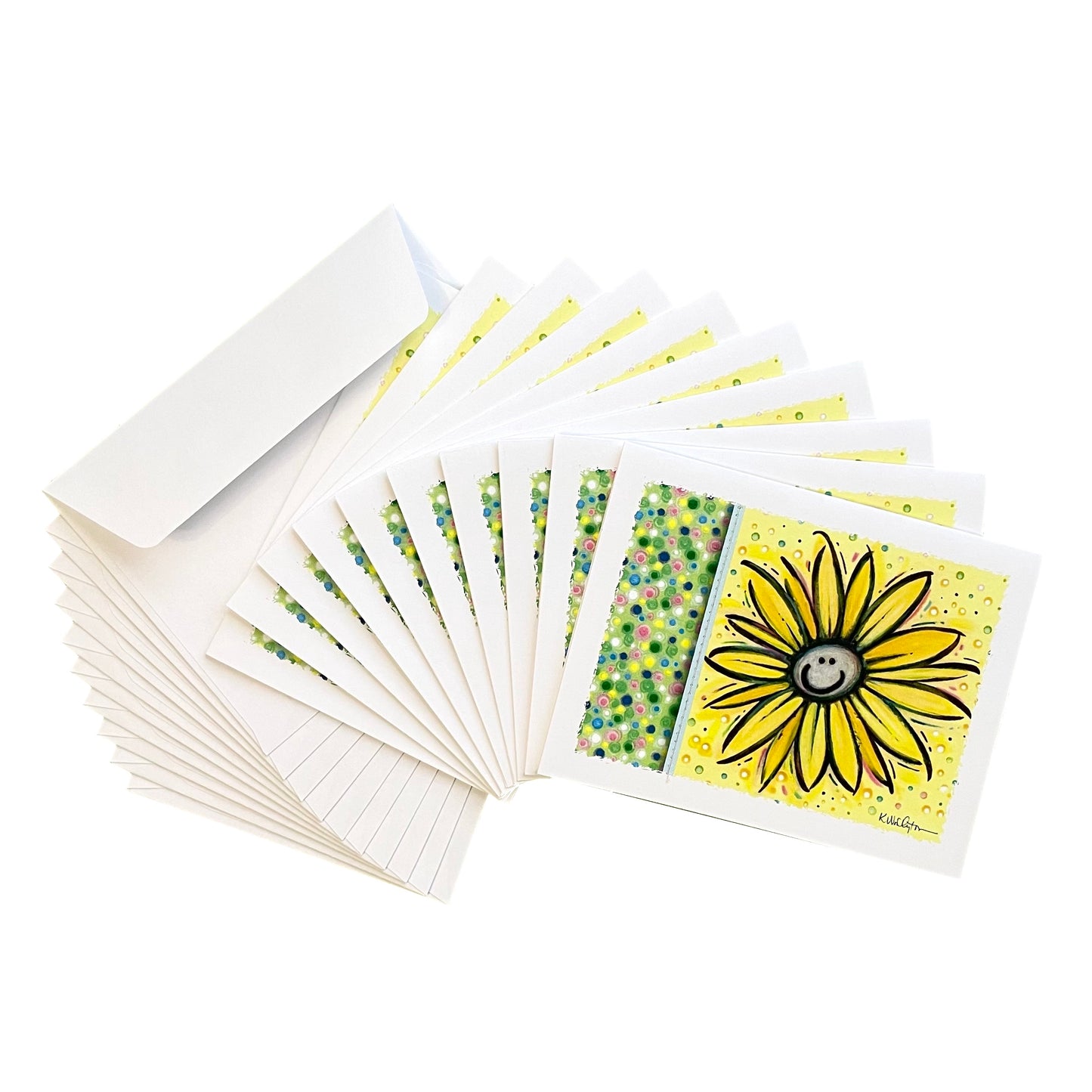 Notecards in smiling yellow daisy and polka dots design displayed in fan of 10 cards and envelopes.
