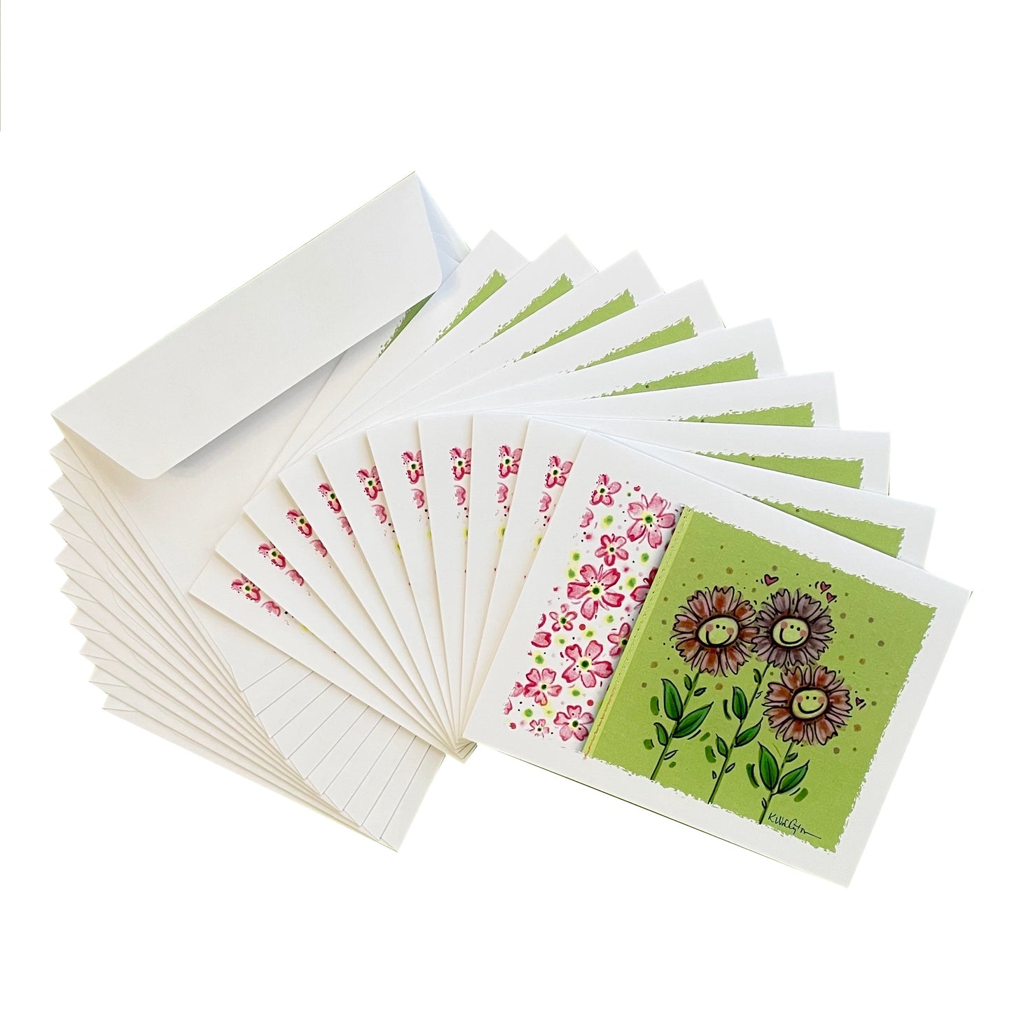 Notecards in smiling zinnias and pink flowers design displayed in fan of 10 cards and envelopes..