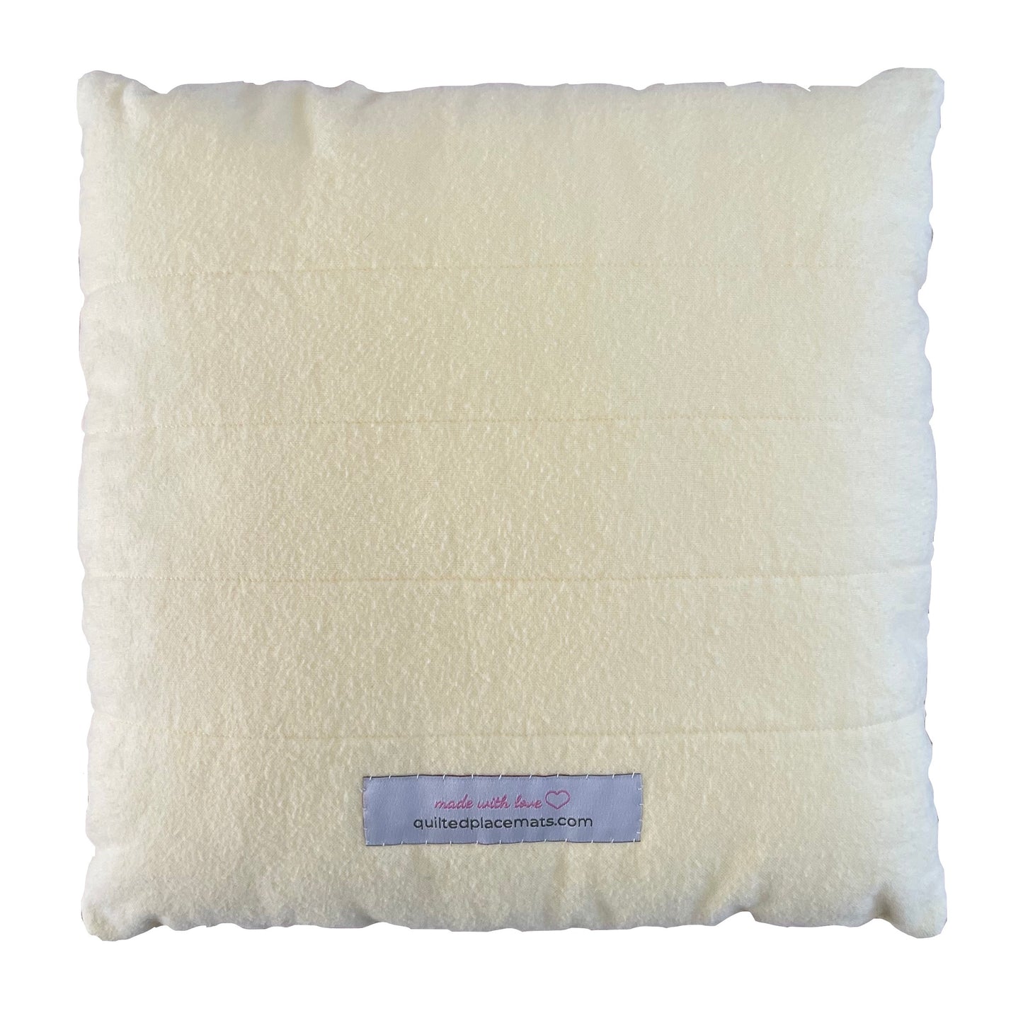 Back view of square smiley daisy throw pillow showing quilted light yellow back and label.