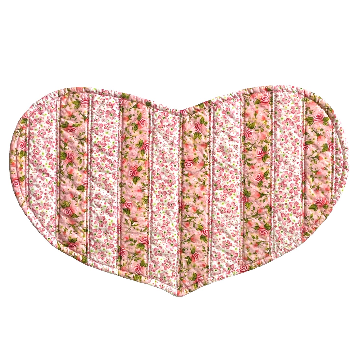 Quilted heart shaped placemat in pink floral stripes.
